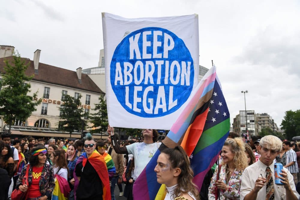 A demonstrator holds a placard reading &quot;Keep abortion legal&quot; as participants gather at the Place de la Bastille, in Paris, during the annual Pride Parade on June 25, 2022. (Alain Jocard/AFP via Getty Images)