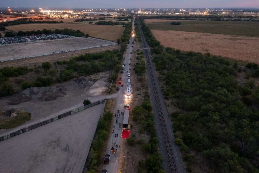 In this aerial view, members of law enforcement investigate a tractor trailer on June 27, 2022 in San Antonio, Texas. According to reports, at least 46 people, who are believed migrant workers from Mexico, were found dead in an abandoned tractor trailer. Over a dozen victims were found alive, suffering from heat stroke and taken to local hospitals. (Jordan Vonderhaar/Getty Images)