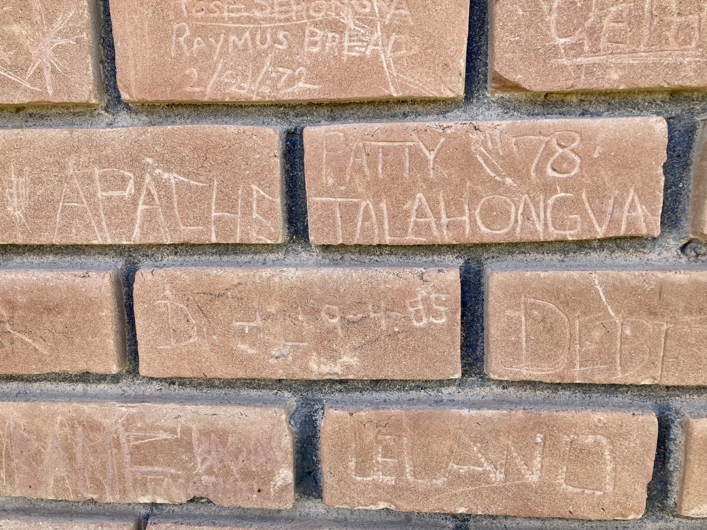 It was an unofficial tradition for students to etch their names in the brick at Memorial Hall. Patty Talahongva, a Hopi student who attended Phoenix Indian in 1978, remembers the day she carved this brick. (Peter O'Dowd)
