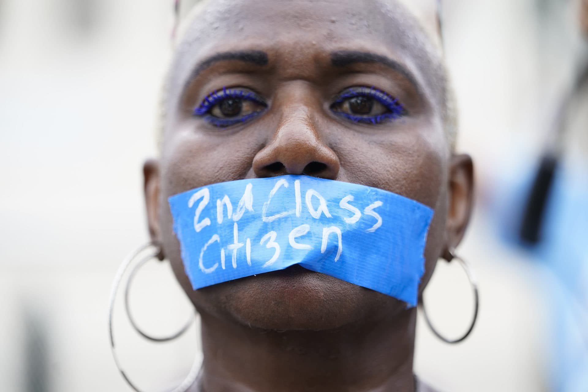 An abortion-rights activist wears tape reading &quot;2nd Class Citizen&quot; on their mouth as they protest outside the Supreme Court on Friday. (Jacquelyn Martin/AP)