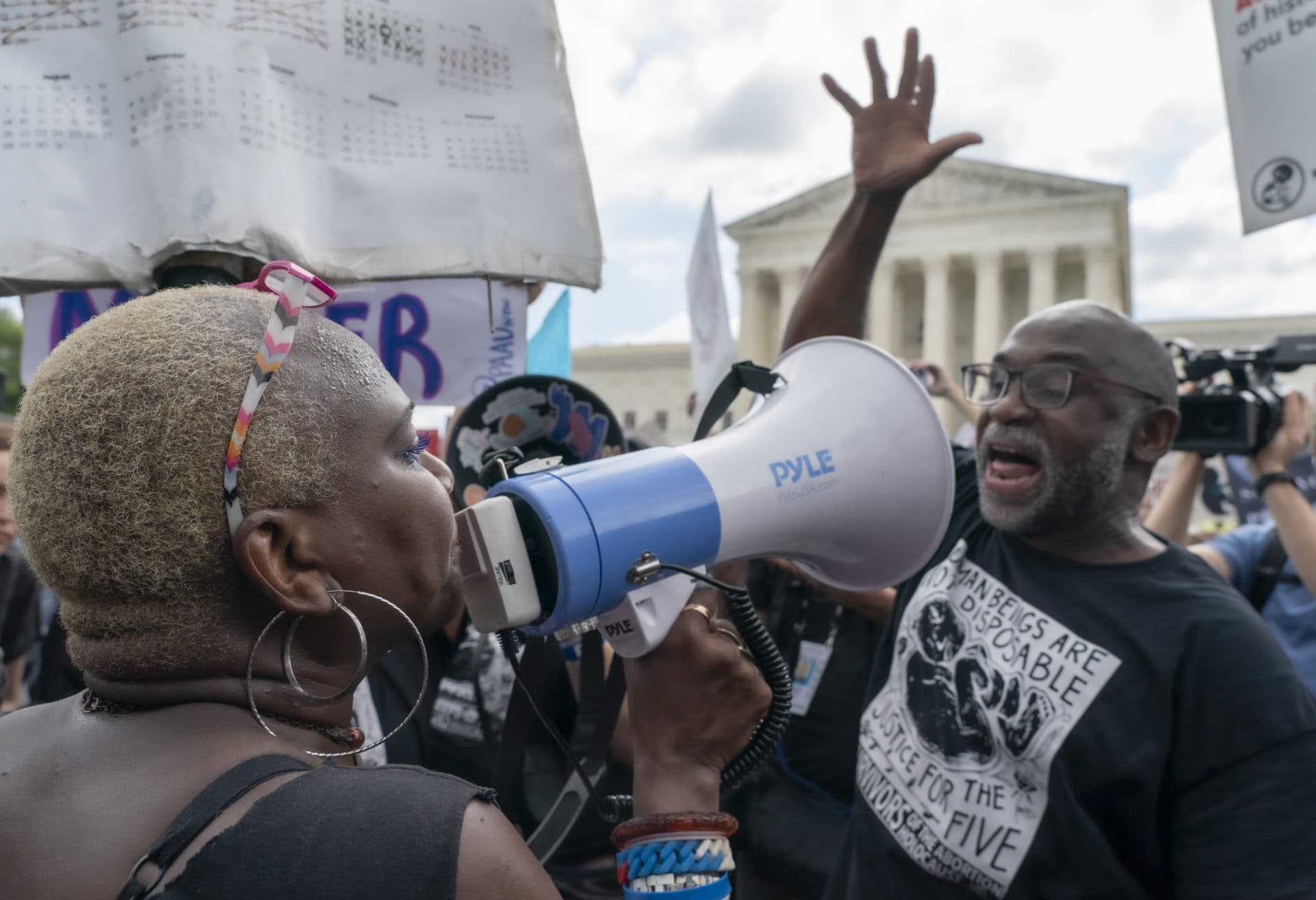 An abortion-rights protester, and an anti-abortion protester face off ahead of the Supreme Court's announcement of its decision to overturn Roe v. Wade. (Gemunu Amarasinghe/AP)