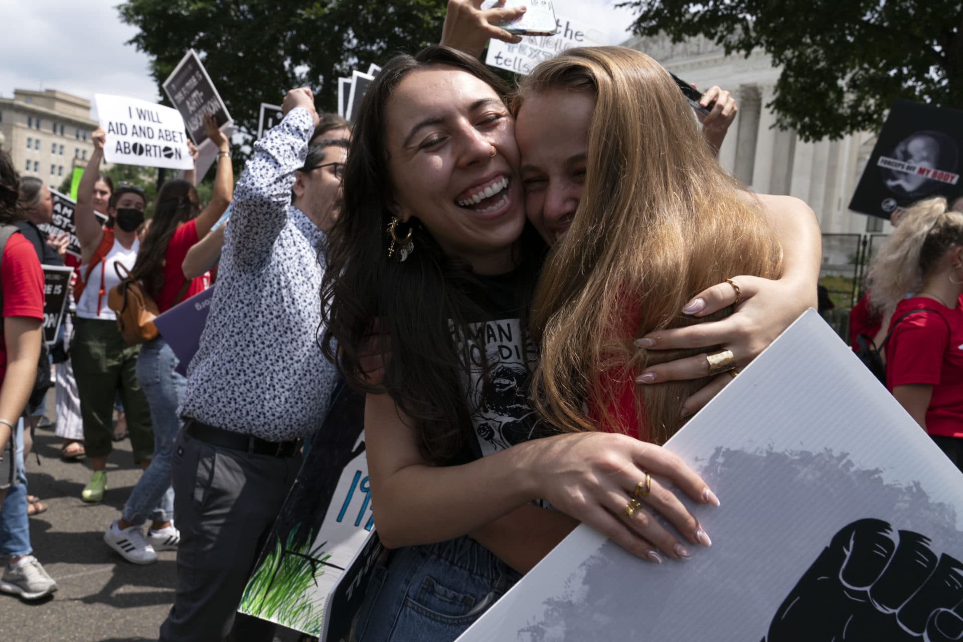 Anti-abortion protesters hug after the news that the Supreme Court overturned Roe v. Wade outside of the court in D.C. (Jose Luis Magana/AP)