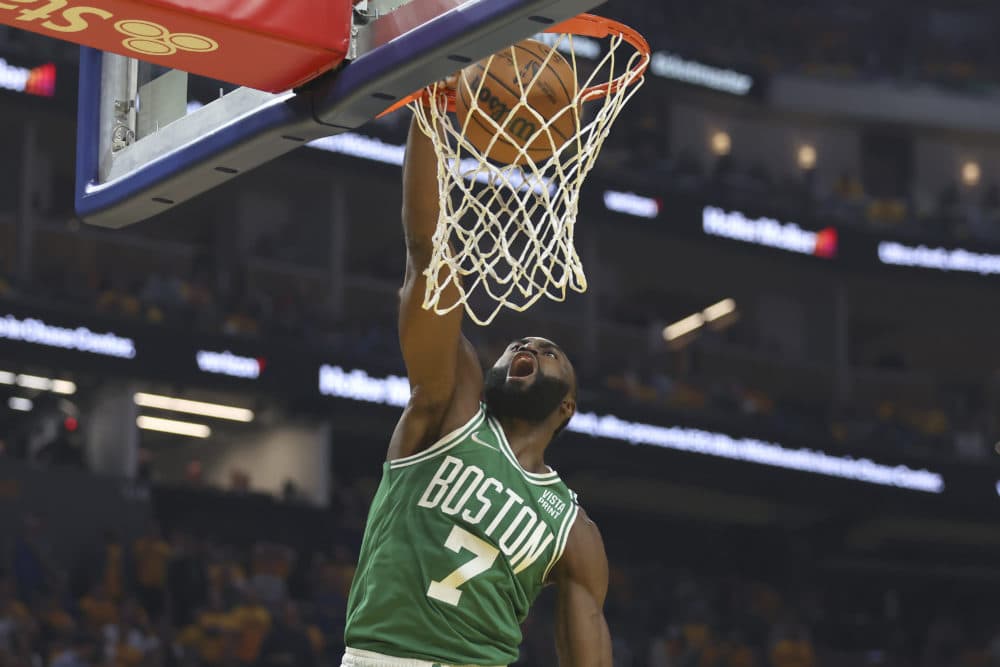 Boston Celtics guard Jaylen Brown (7) dunks against the Golden State Warriors during the first half of Game 1 of basketball's NBA Finals in San Francisco, Thursday, June 2, 2022. (AP Photo/Jed Jacobsohn)