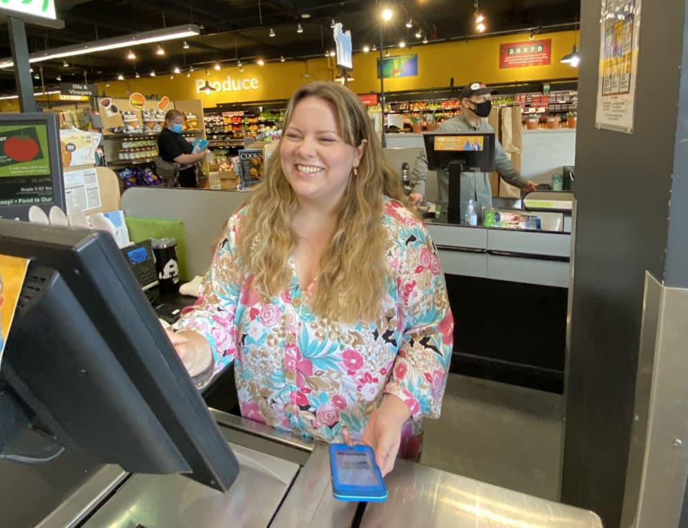 Hayley Ranolde takes a digital BerkShares payment at The Berkshires Food Co-op (Credit Leah Barber)