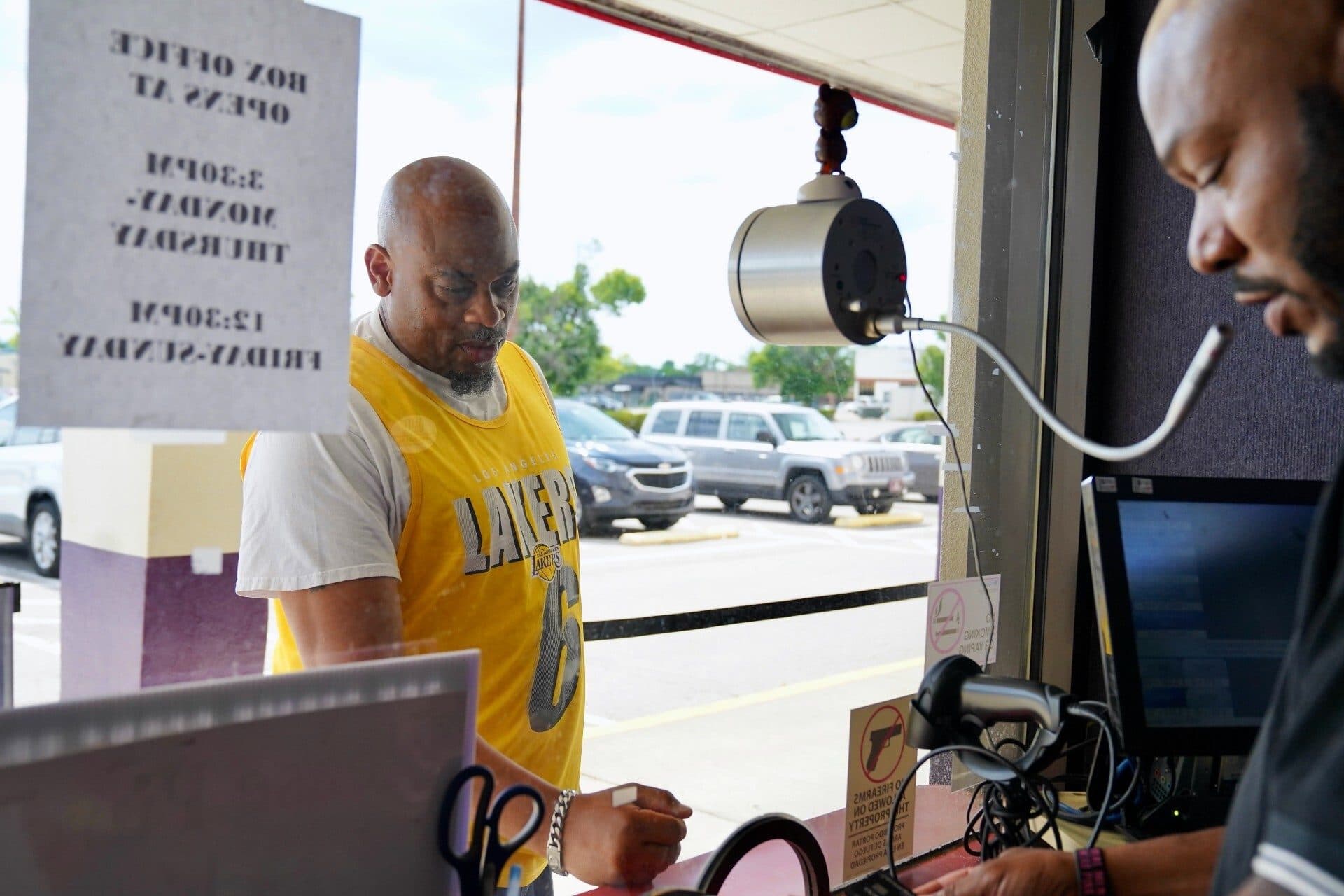 A customer buys a movie ticket at Village 8 Theater. (Stephanie Wolf)