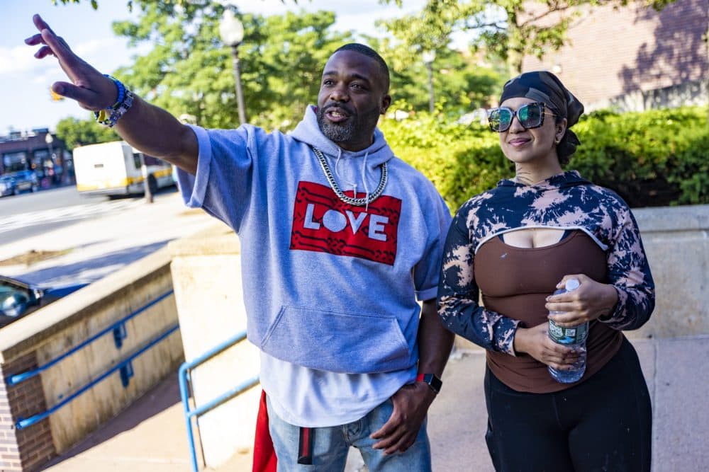 Artist Rob “ProblaK” Gibbs and Rixy discuss the work she has done on “Rita’s Spotlght” shortly before an artist talk event in Allston. (Jesse Costa/WBUR)