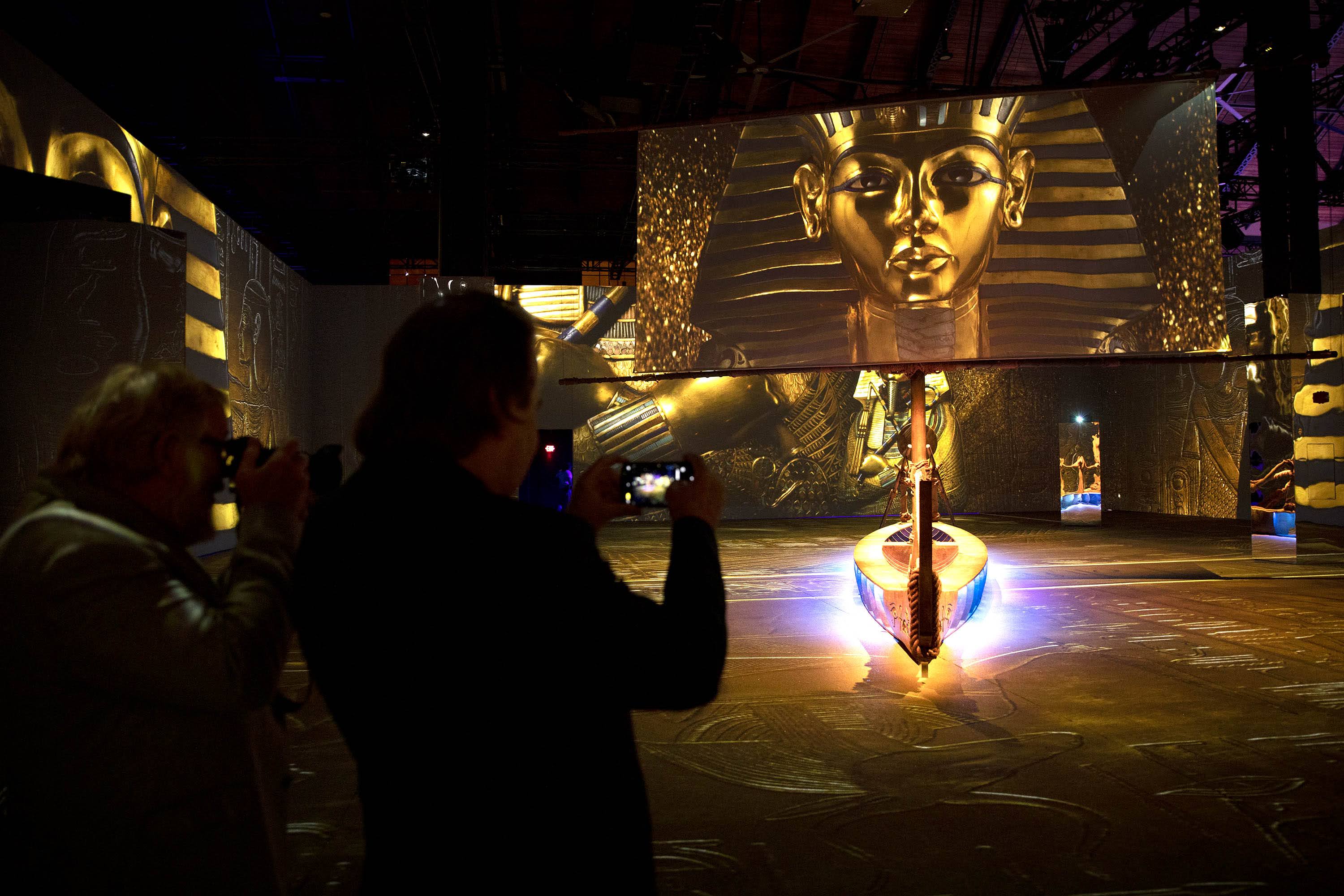 Creative Producer Mark Lach shoots some video in the &quot;Journey to the Afterlife&quot; room at the &quot;Beyond King Tut&quot; immersive experience in Boston. (Robin Lubbock/WBUR)