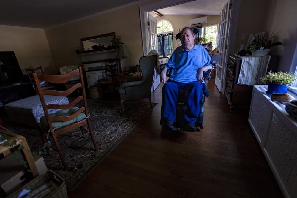 Charlie Carr moves through the living room of his Methuen home. (Jesse Costa/WBUR)