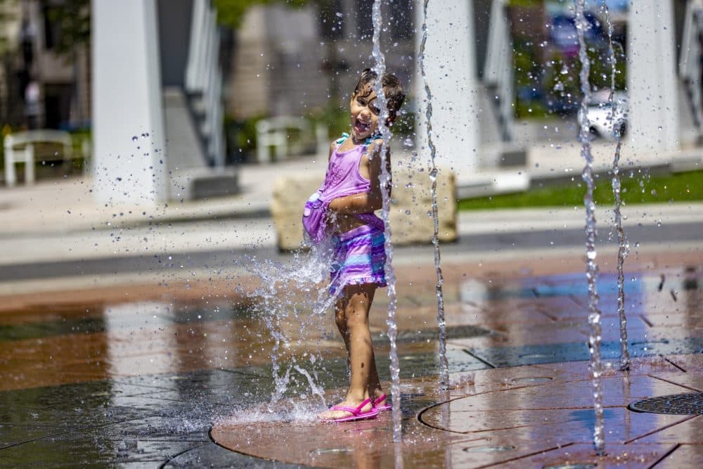 Four-year-old Paulina plays at the Rings Fountain at the Greenway while she and her family are visiting Boston from Puerto Rico. (Jesse Costa/WBUR)