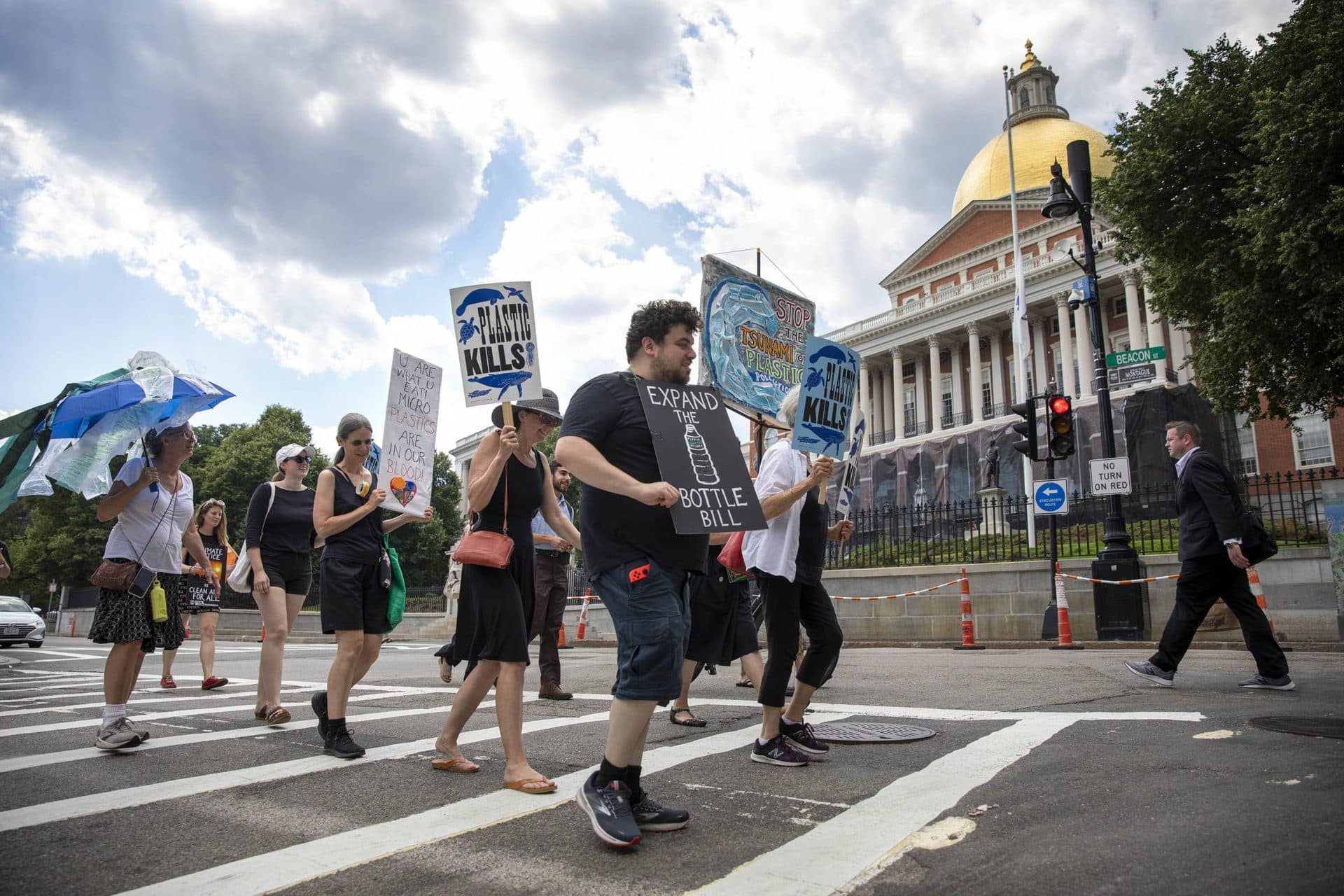 Beyond Plastics demonstrators march past the Massachusetts State House. (Robin Lubbock/WBUR)