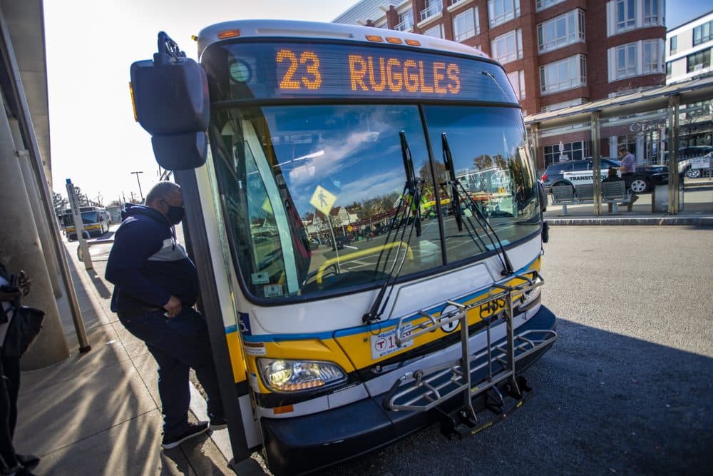 A rider boards the 23 bus in Boston. (Jesse Costa/WBUR)