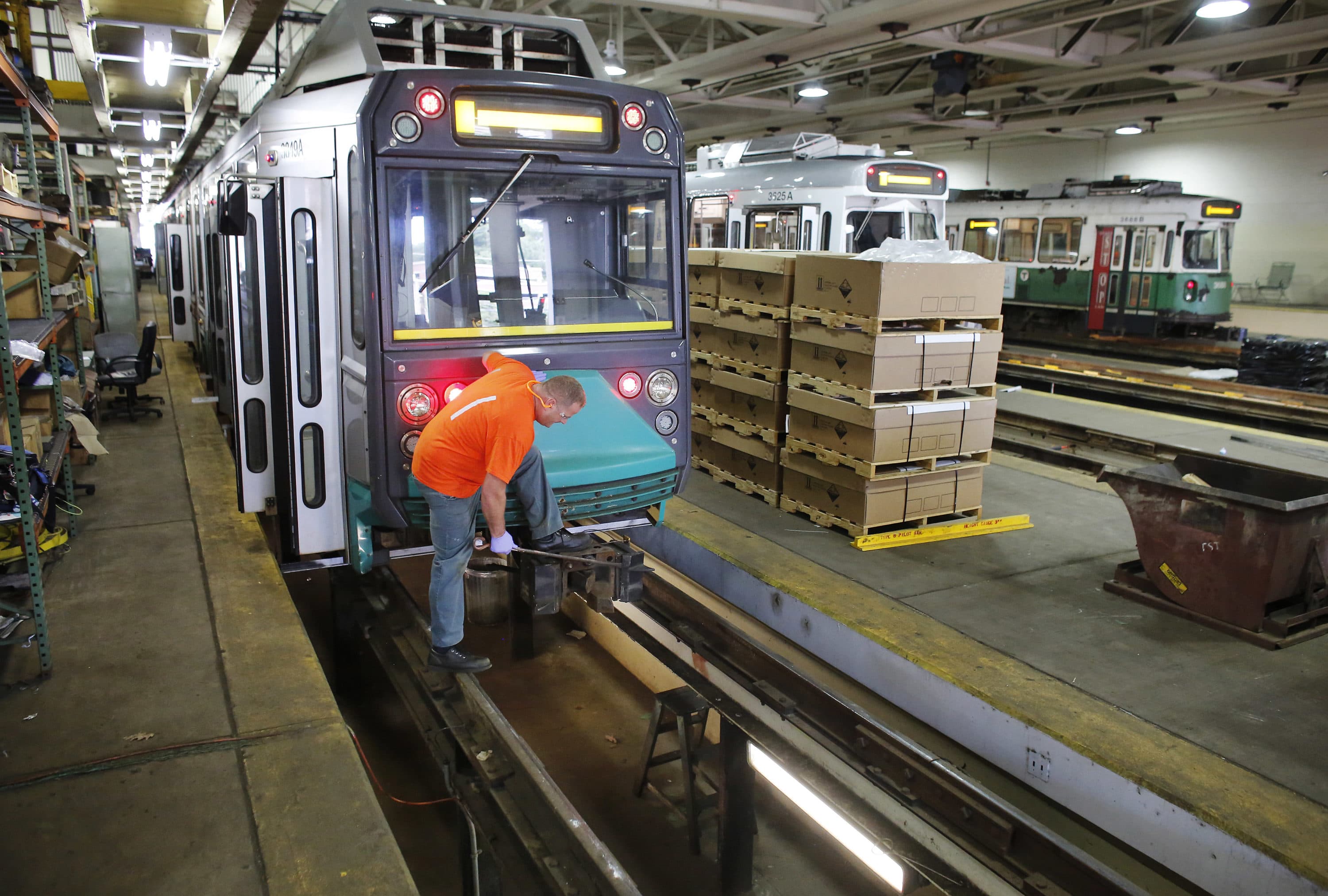 Light rail repairer Kevin Murphy, of Methuen, Mass., works on a railcar at the Massachusetts Bay Transportation Authority's Riverside maintenance facility in Newton, Mass.(AP Photo/Steven Senne)
