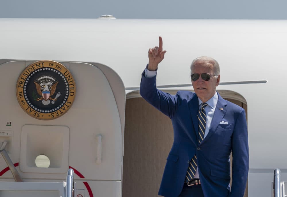 President Joe Biden gestures as he board Air Force One. (Gemunu Amarasinghe/AP)