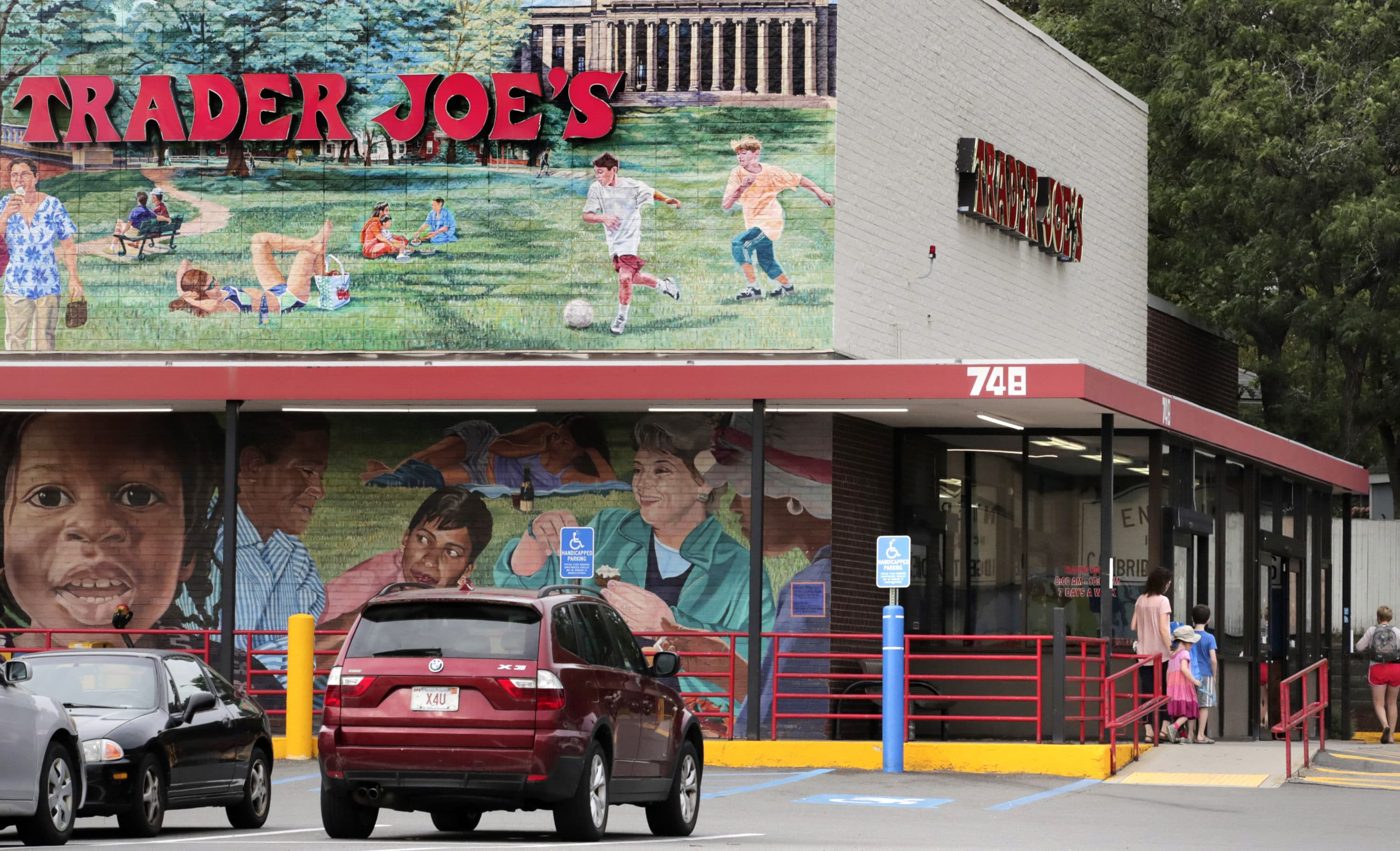 Customers walk to a Trader Joe's market in Cambridge, Mass. Employees of a Trader Joe's grocery store in Hadley, Massachusetts became the latest workers at a major company to approve a labor union. (Charles Krupa/AP)