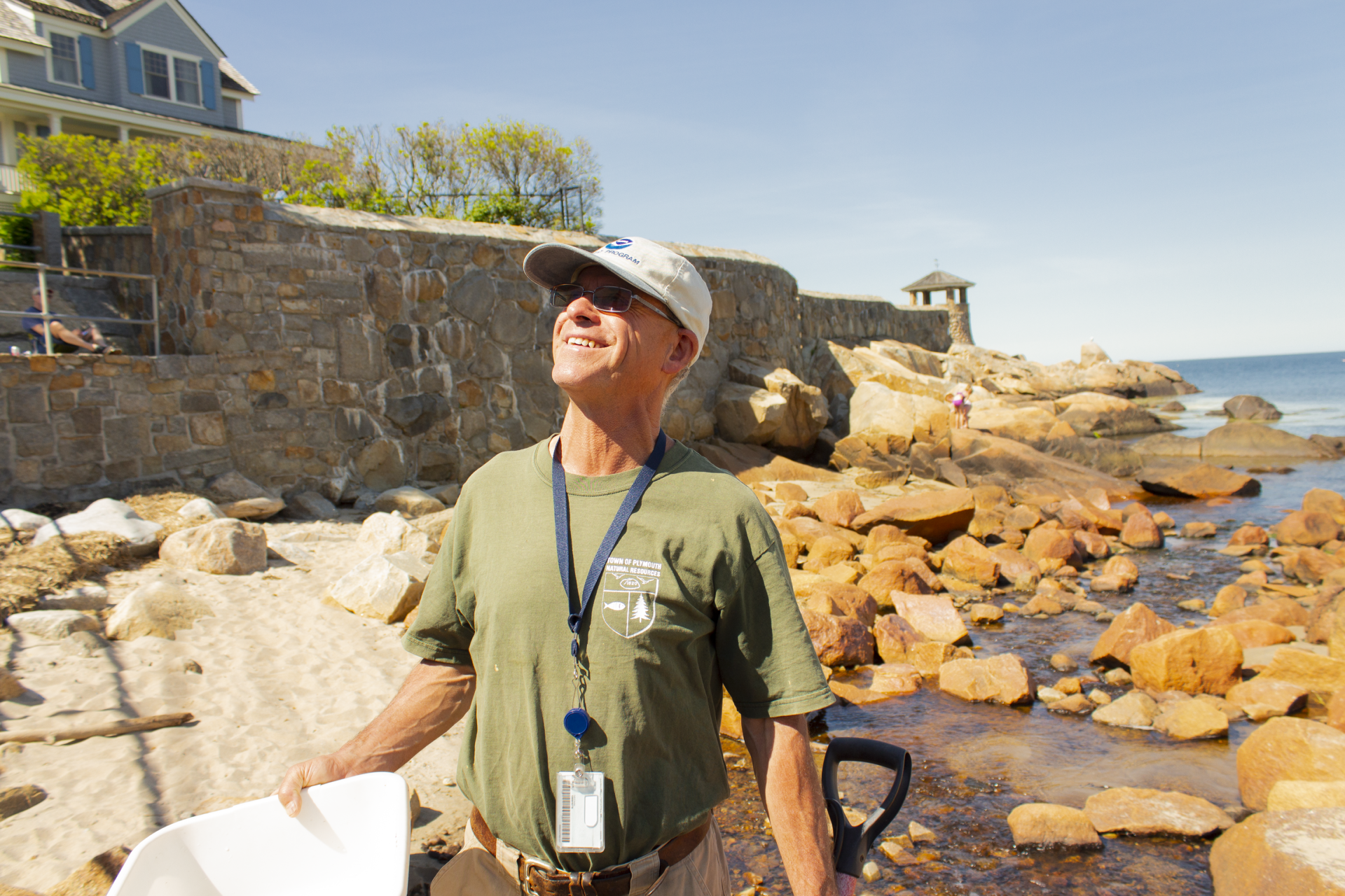 Eric Hutchins wades through Mill Brook on Front Beach in Rockport. (Wilder Fleming/WBUR)