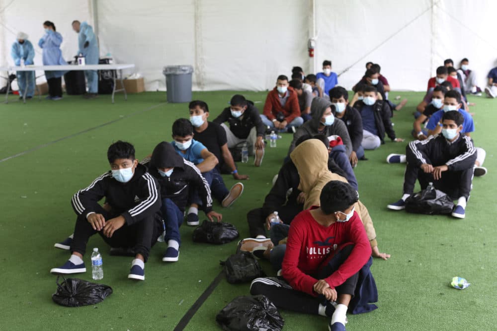 Young migrants wait to be tested for COVID-19 at the Donna Department of Homeland Security holding facility, the main detention center for unaccompanied children in the Rio Grande Valley in Donna, Texas on March 30, 2021. (Photo by Dario Lopez-Mills/POOL/AFP via Getty Images)