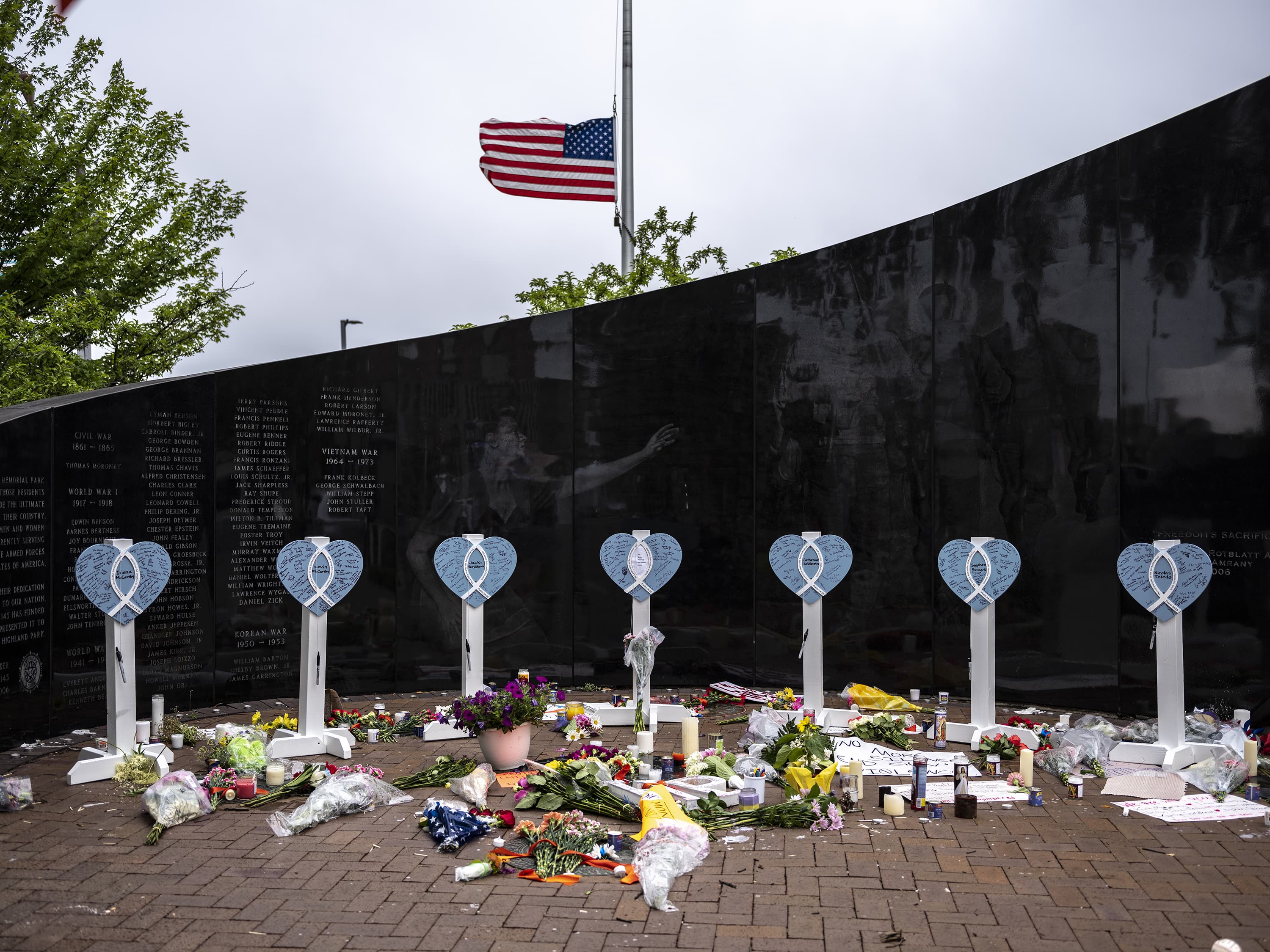 An American flag flies at half-staff near a memorial for the victims of a mass shooting at a Fourth of July parade, on July 6, 2022 in Highland Park, Illinois. (Jim Vondruska/Getty Images)
