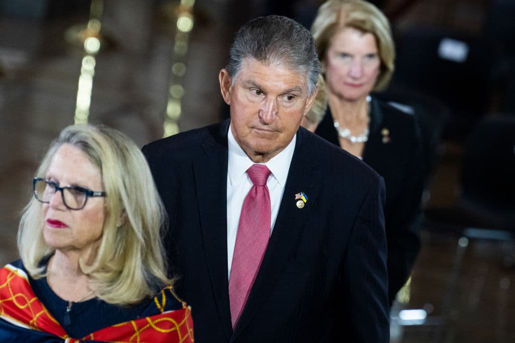 Rep. Carol Miller, R-W.Va., Sen. Joe Manchin, D-W.Va., and Sen. Shelley Moore Capito, R-W.Va., pay respects to Hershel Woodrow Woody Williams, the last Medal of Honor recipient of World War II to pass away, in the U.S. Capitol Rotunda as his remains lie in honor in Washington, D.C., on Thursday, July 14, 2022. (Tom Williams/CQ-Roll Call, Inc via Getty Images)