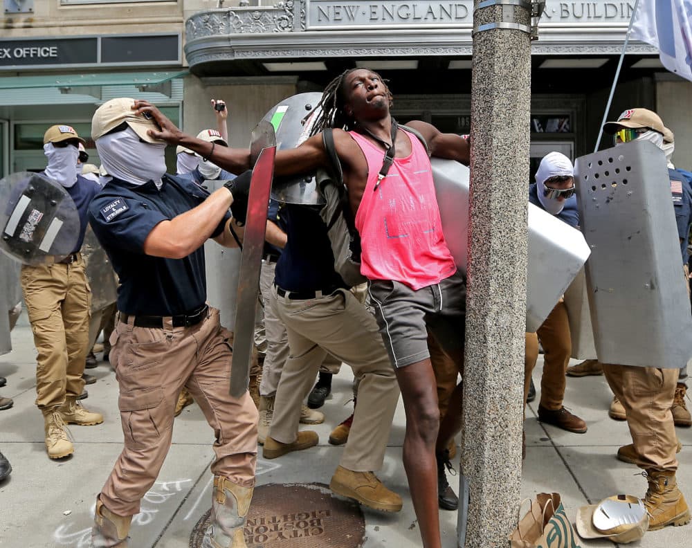 A Black man is confronted by white supremacist group The Patriot Front at it marches through Boston on July 2. (Stuart Cahill/MediaNews Group/Boston Herald via Getty Images)