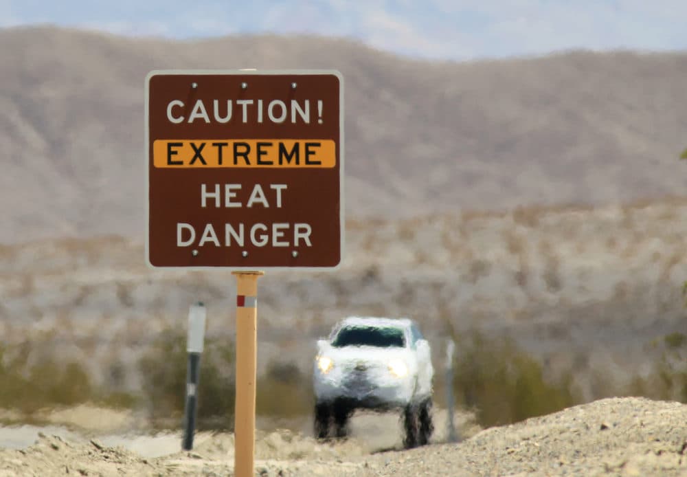 Heat waves rise near a heat danger warning sign in Death Valley National Park. (David McNew/Getty Images)