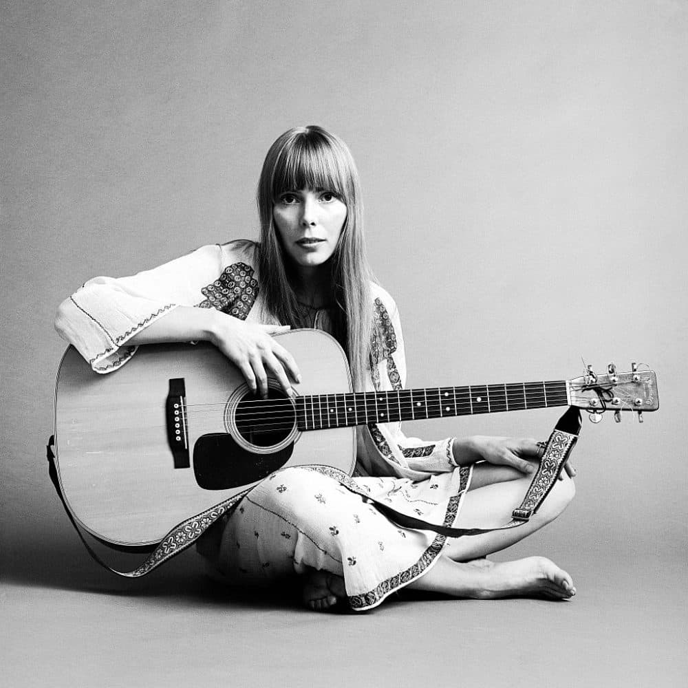 Portrait ofJoni Mitchell seated on the floor with her acoustic guitar in her lap. This image was from a shoot for the fashion magazine Vogue, Nov. 20, 1968. (Jack Robinson /Hulton Archive/Getty Images)