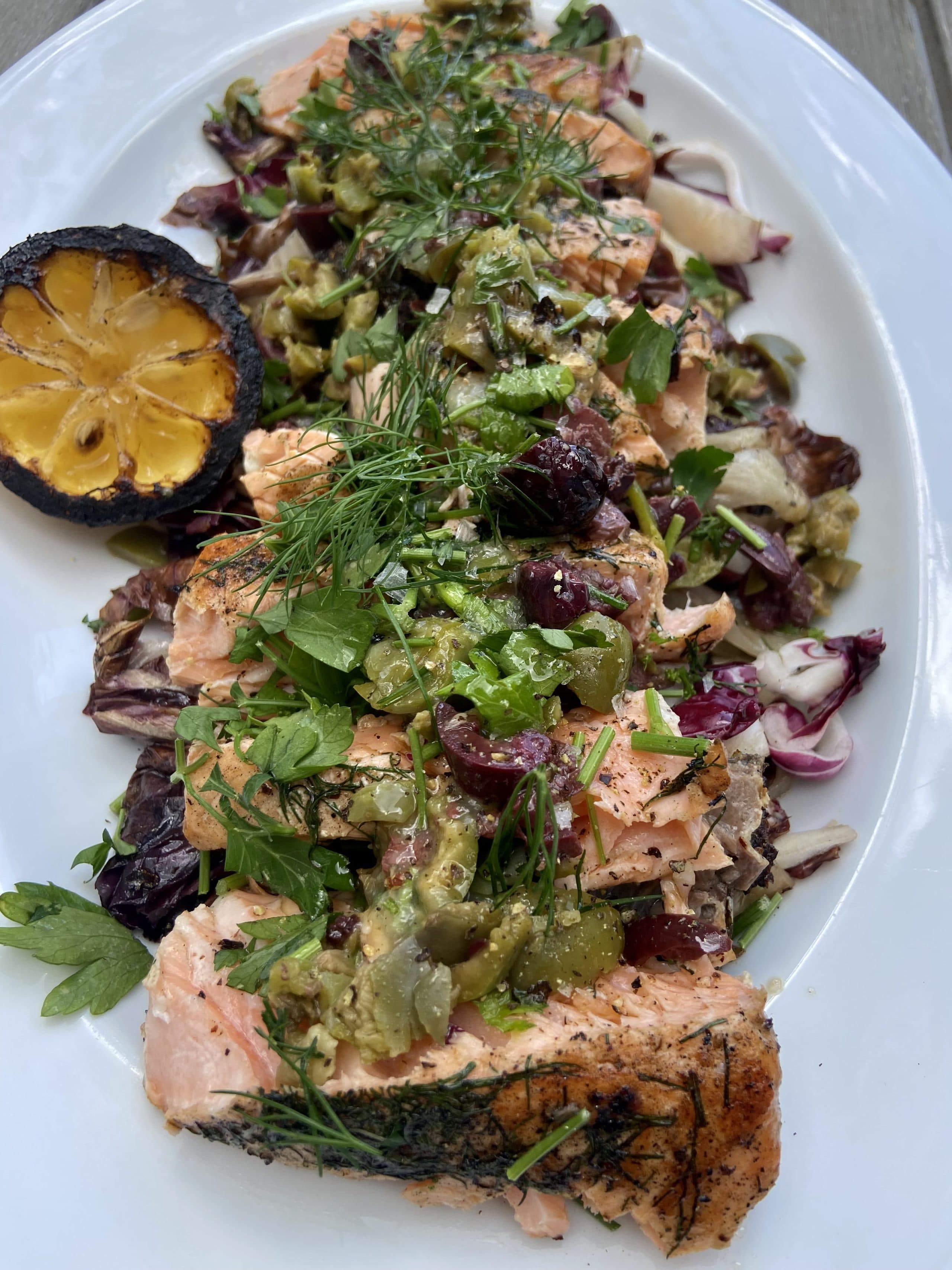 Grilled salmon and radicchio salad with grilled lemon and olive topping. (Kathy Gunst/Here & Now)