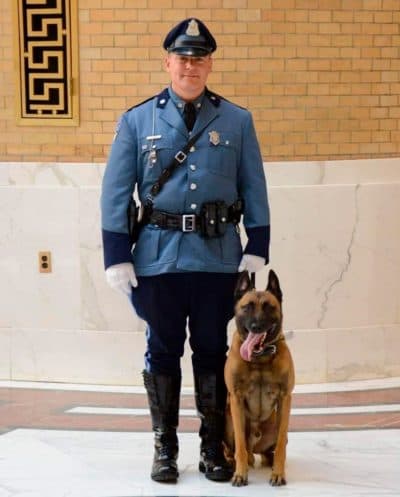 Massachusetts State Police Trooper David Stucenski standing with MSP K9 Frankie. (Massachusetts State Police via AP)