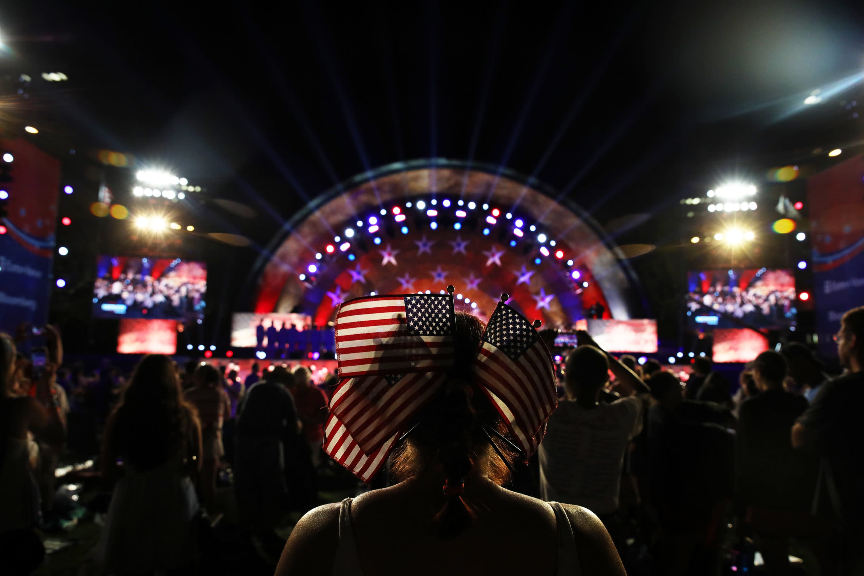 A woman watches the Boston Pops Orchestra perform during the Boston Pops Fireworks Spectacular at the DCR Hatch Shell on the Esplanade in Boston, MA on July 4, 2019. (Erin Clark for The Boston Globe via Getty Images)