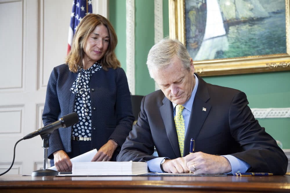 Gov. Charlie Baker signs a bill on July 29, 2022. (State House News Service)