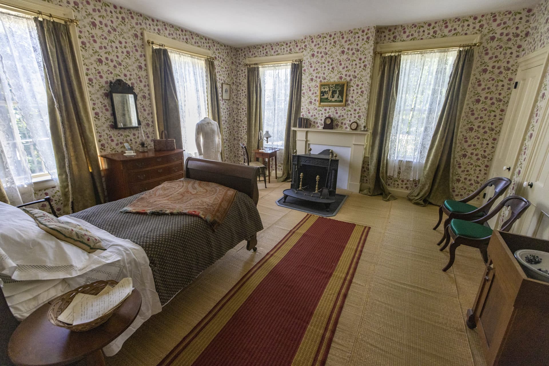 In the museum, Emily Dickinson's bedroom houses many of the poet's possessions, including her famous white dress.  Bed pillow and coverlet Apple TV+ shows "Dickinson."  (Jesse Costa/WBUR)