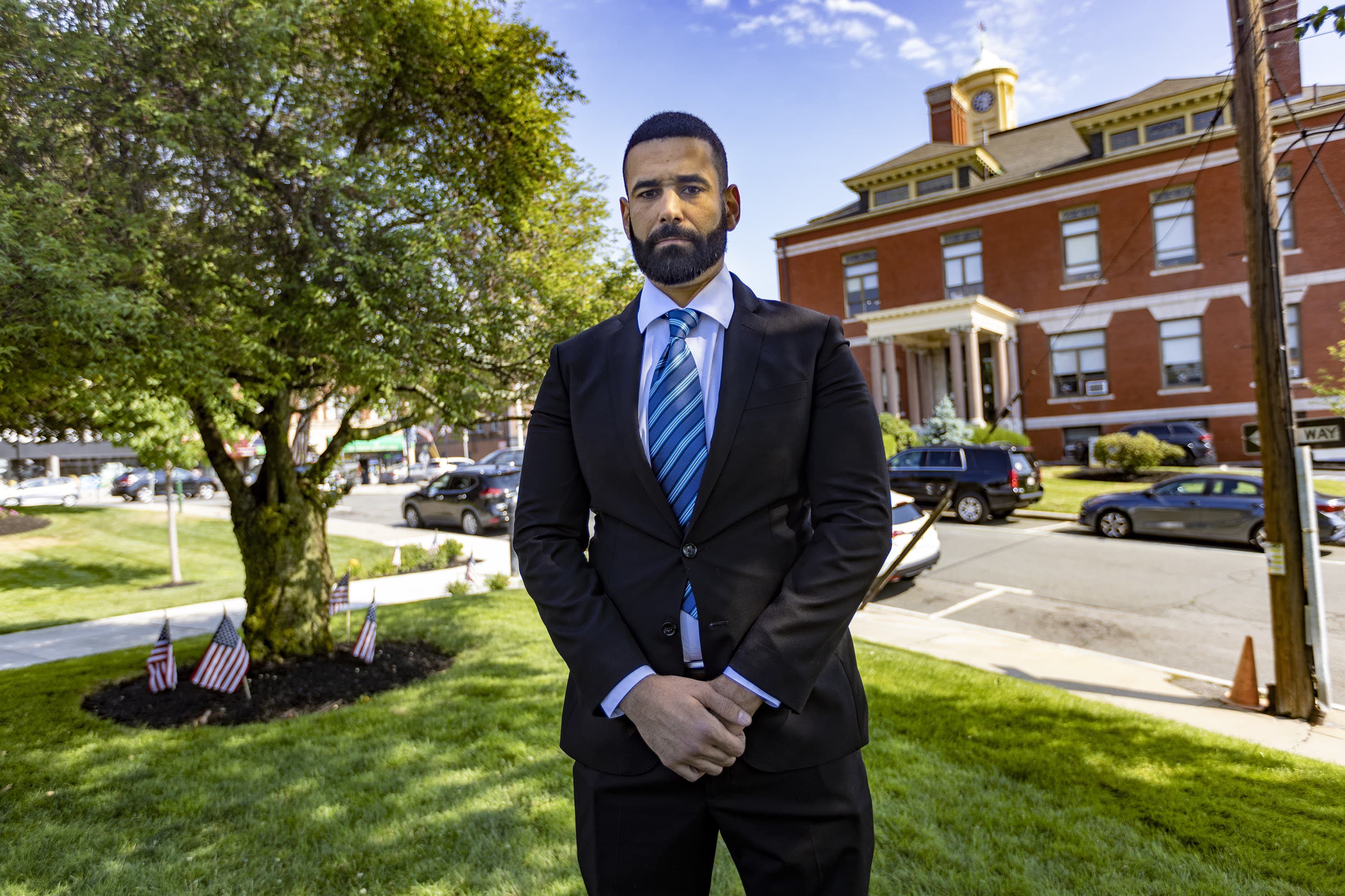 Youness Elalam standing outside of Revere City Hall before his arbitration hearing. (Jesse Costa/WBUR)