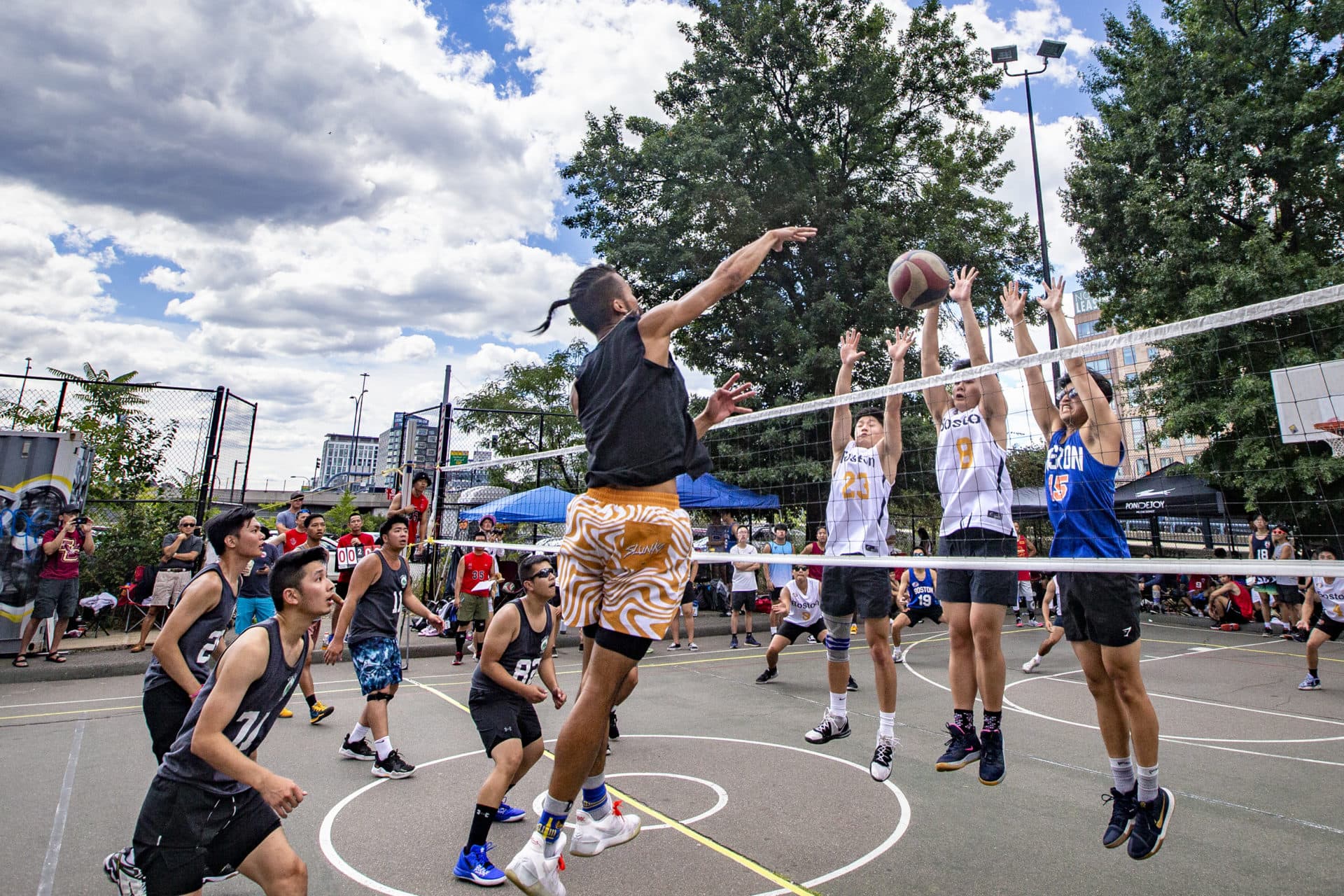 The Boston Hurricanes' defenders attempt to block a spike in a match against the Boston Rising Tide at Reggie Wong Memorial Park in Chinatown. (Jesse Costa/WBUR)