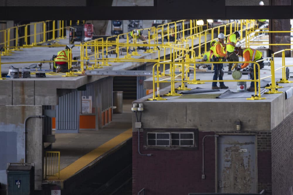 An MBTA construction crew works on the Sullivan Square station platform. (Jesse Costa/WBUR)