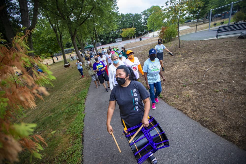 Michelle Fujii leads a group of seniors from the Boston Center of Youth and Families Grove Hall Senior Center and Blake Estates for a sacred walk around Iacono Park during one of the taiko events. (Jesse Costa/WBUR)