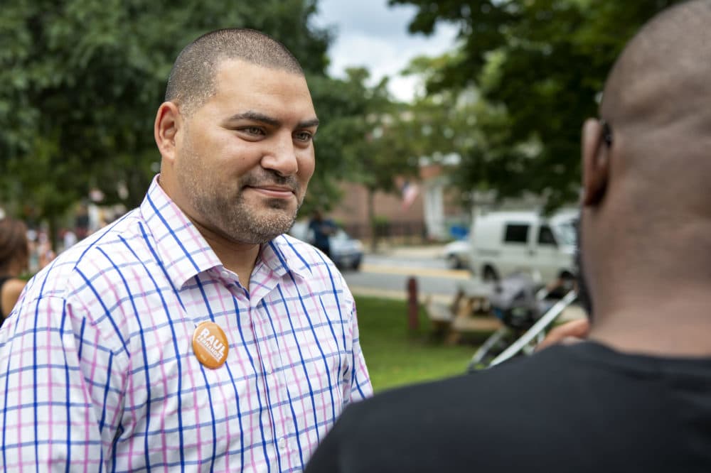 Raul Fernandez, a candidate for Massachusetts state representative, talks to a supporter at a campaign rally in Brookline. (Robin Lubbock/WBUR)