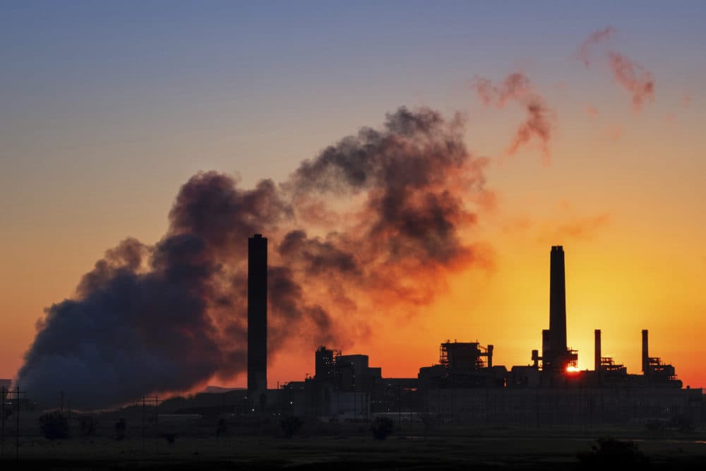The Dave Johnson coal-fired power plant is silhouetted against the morning sun in Glenrock, Wyo. (J. David Ake/AP)