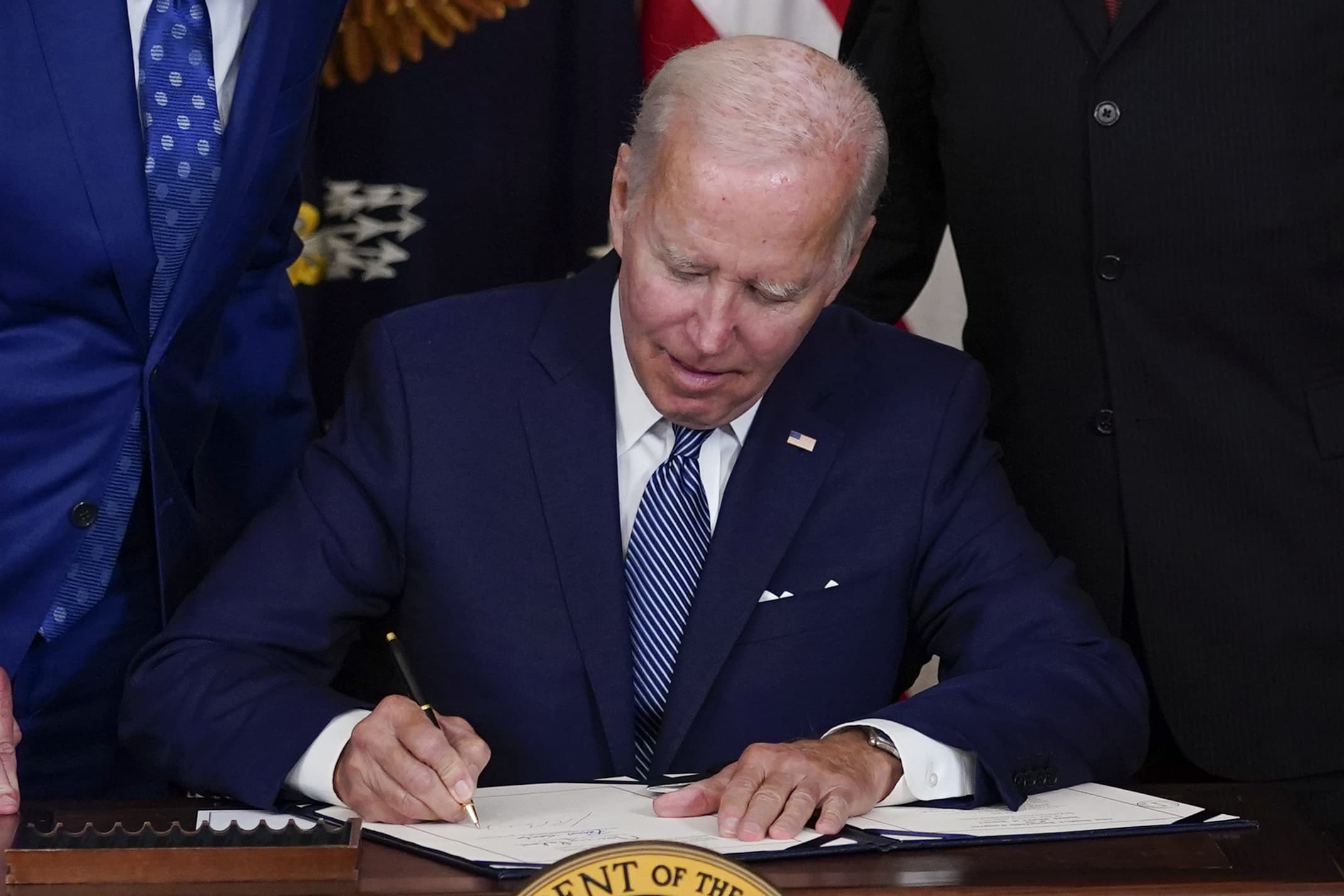 President Joe Biden signs the Democrats' landmark climate change and health care bill in the State Dining Room of the White House in Washington, Tuesday, Aug. 16, 2022. (Susan Walsh/AP)