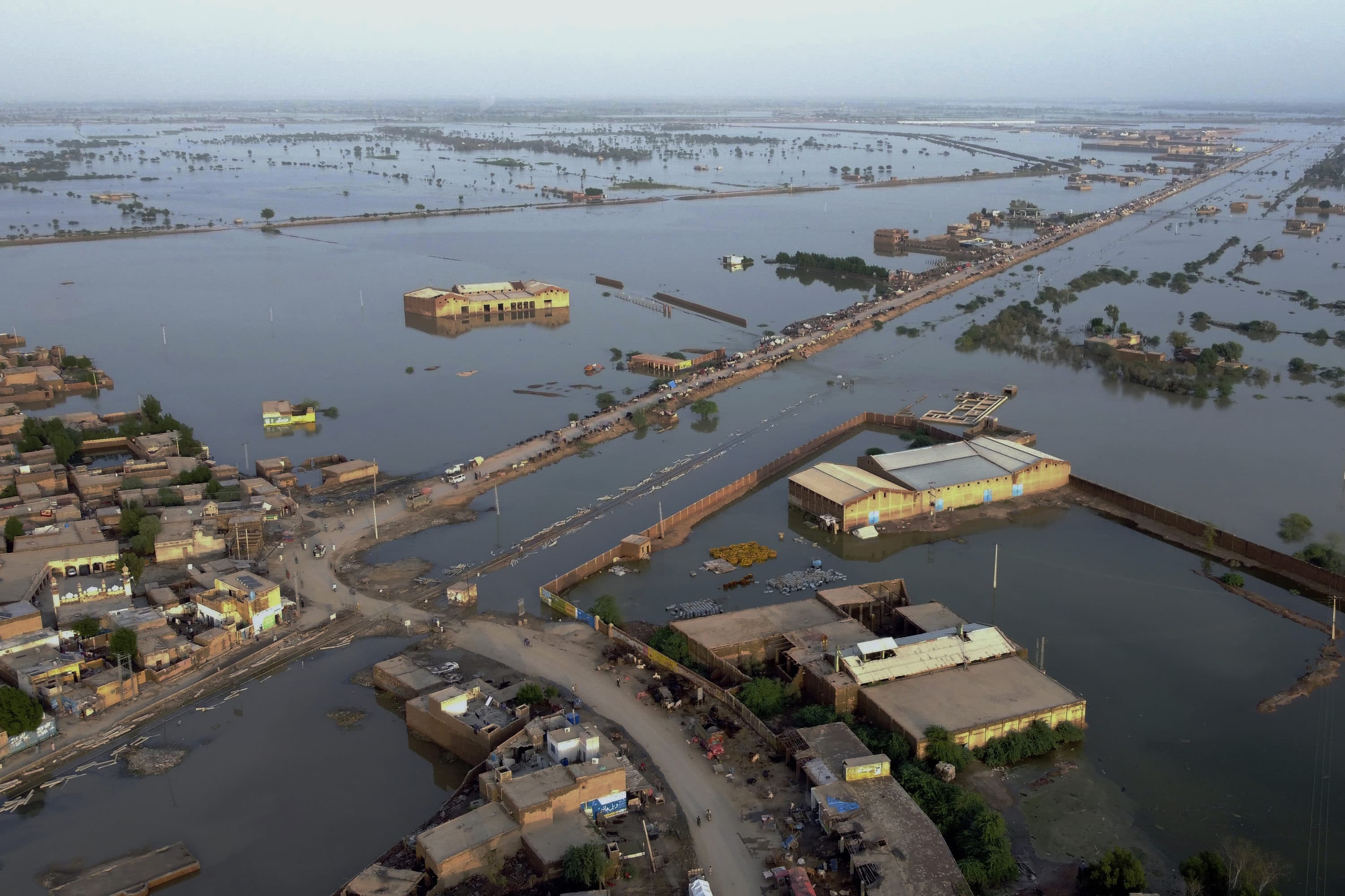 Homes are surrounded by floodwaters in Sohbat Pur city, Pakistan. (Zahid Hussain/AP)