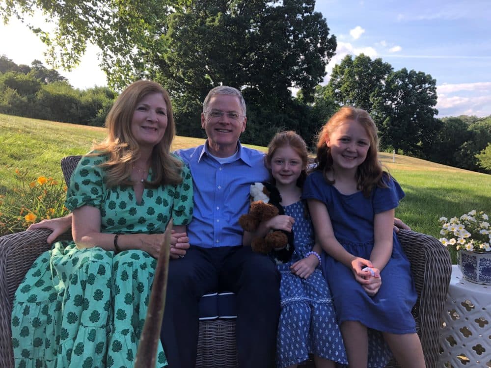 Chris and Leslie Doughty at their home in Wrentham, with two of their grandchildren, Halle and Isla (Anthony Brooks/WBUR)