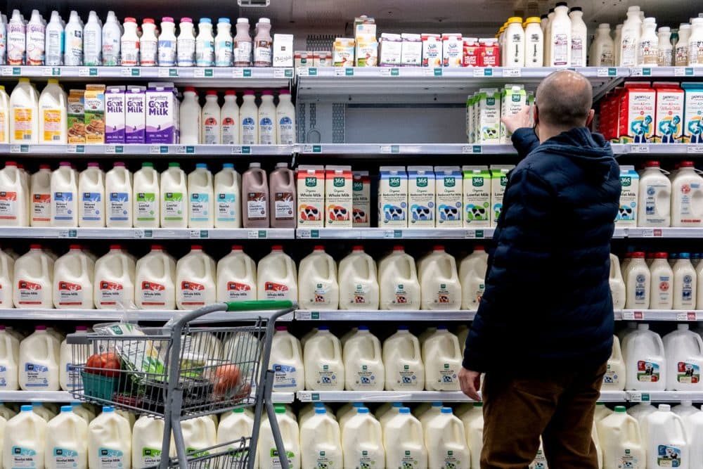 A shopper walks through the dairy aisle of a grocery store in Washington, DC, on Feb. 19, 2022. (Stefani Reynolds/AFP via Getty Images)
