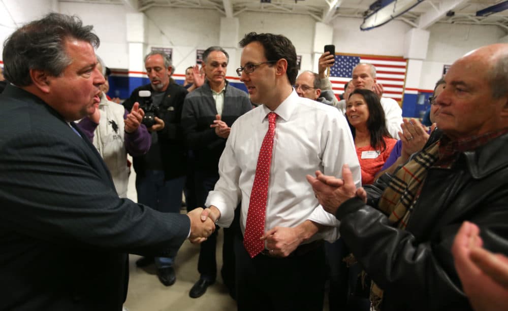 In 2015, Revere Mayor Dan Rizzo (left) congratulates Brian Arrigo (right) after a recount in the mayoral election. Arrigo is currently mayor of Revere. (Jonathan Wiggs/The Boston Globe via Getty Images)