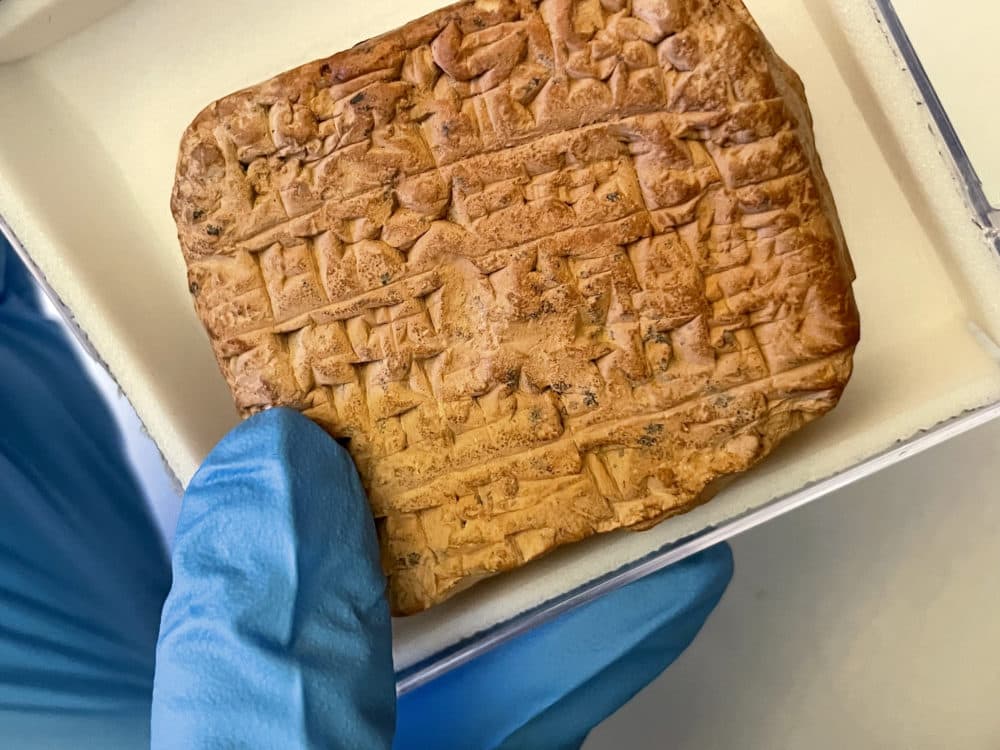 Philip Jones of the Penn Museum shows a tablet with the Sumerian bar joke written in large, untidy cuneiform script. (WBUR/Ben Brock Johnson)