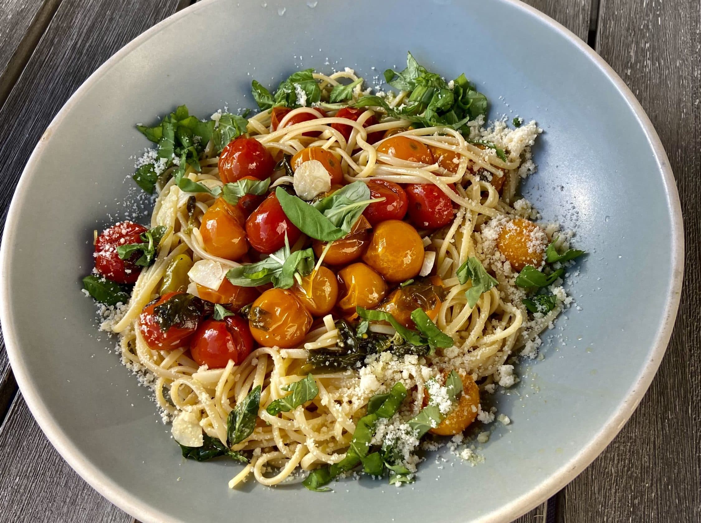 Linguine with cherry tomato confit, basil, pine nuts and arugula. (Kathy Gunst/Here &amp; Now)