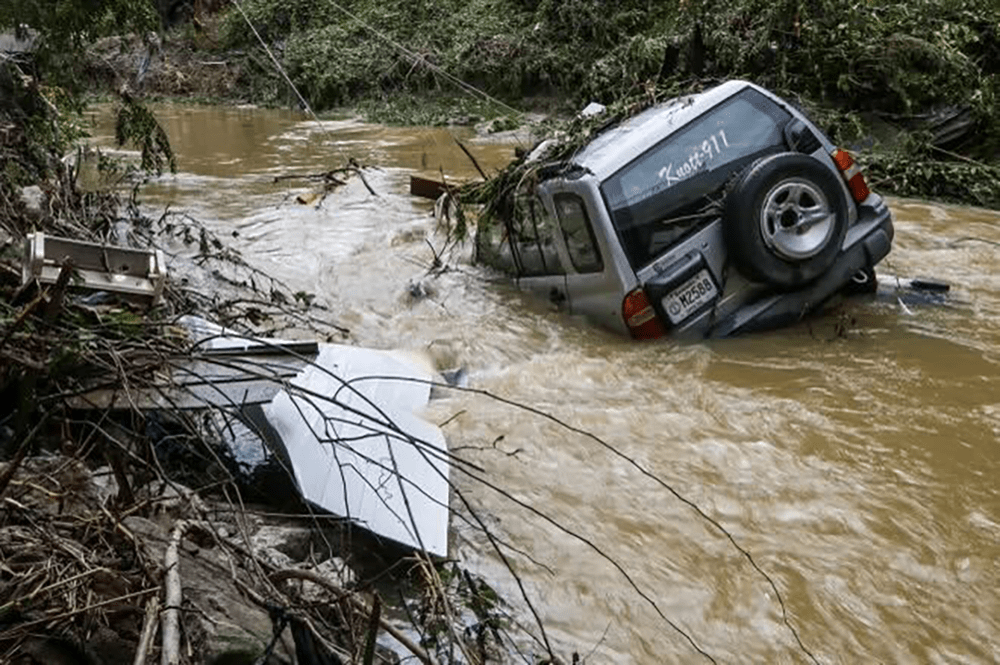A can sinks in the aftermath of flooding. (Joe Arvin)
