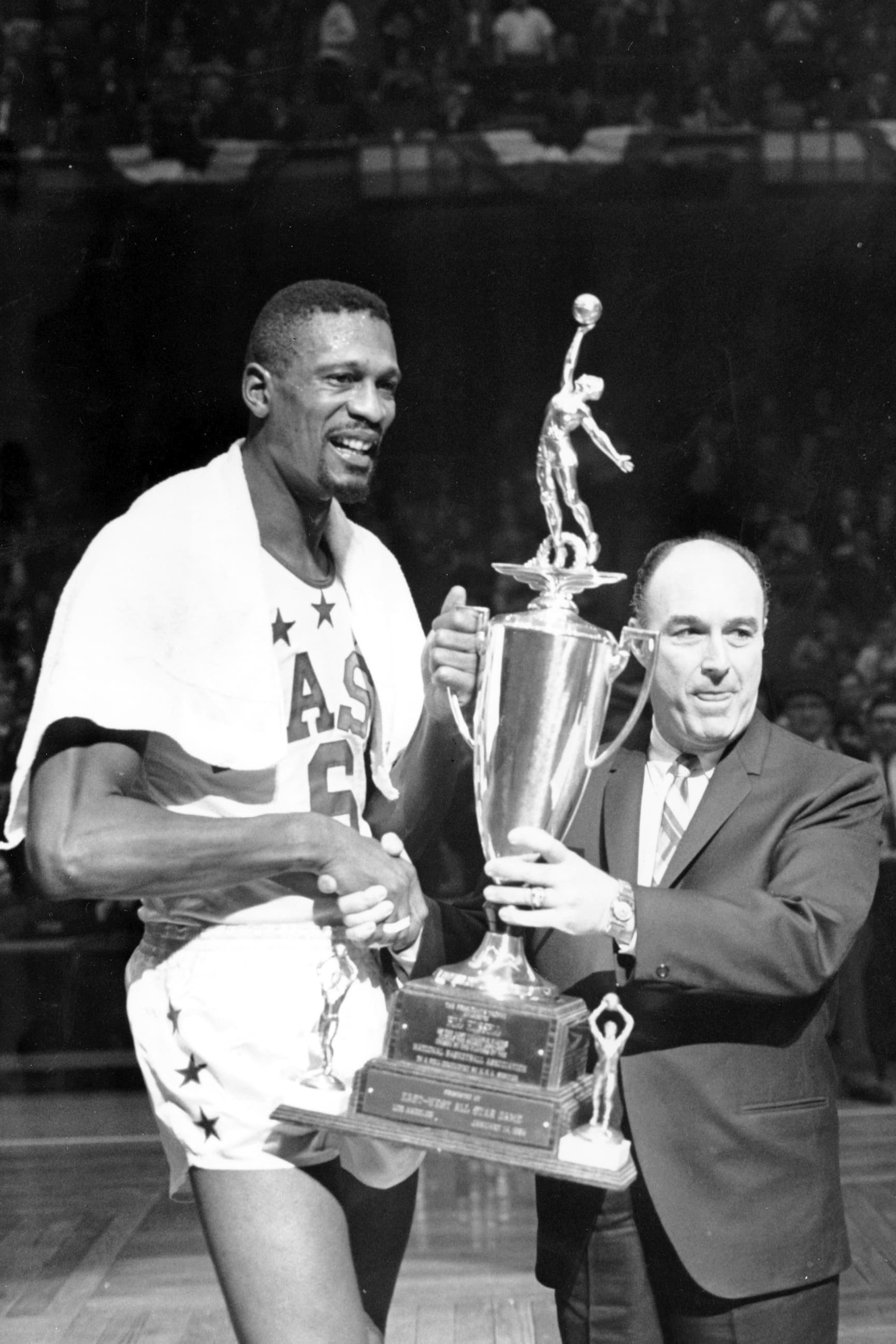 Bill Russell receives &quot;Player of the Year&quot; award from National Basketball Association Commissioner Walter Kennedy during half time of the All-Stars game at Boston Garden on Jan. 14, 1964. (AP)