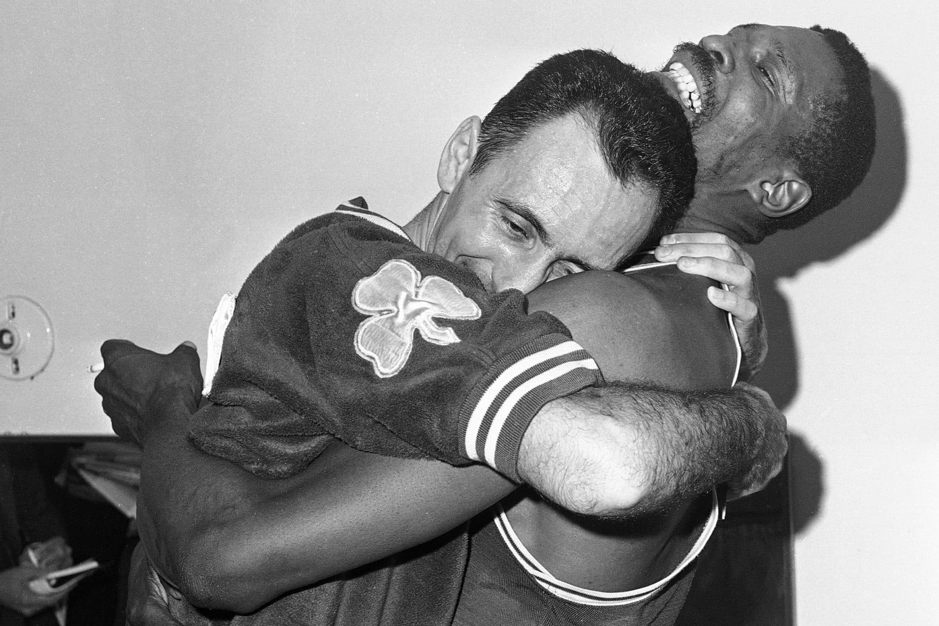 Bill Russell embraces teammate Bob Cousy on April 24, 1963 in the locker room after the Celtics won their fifth consecutive NBA championship, beating the Lakers in Los Angeles. (Ed Widdis/AP)