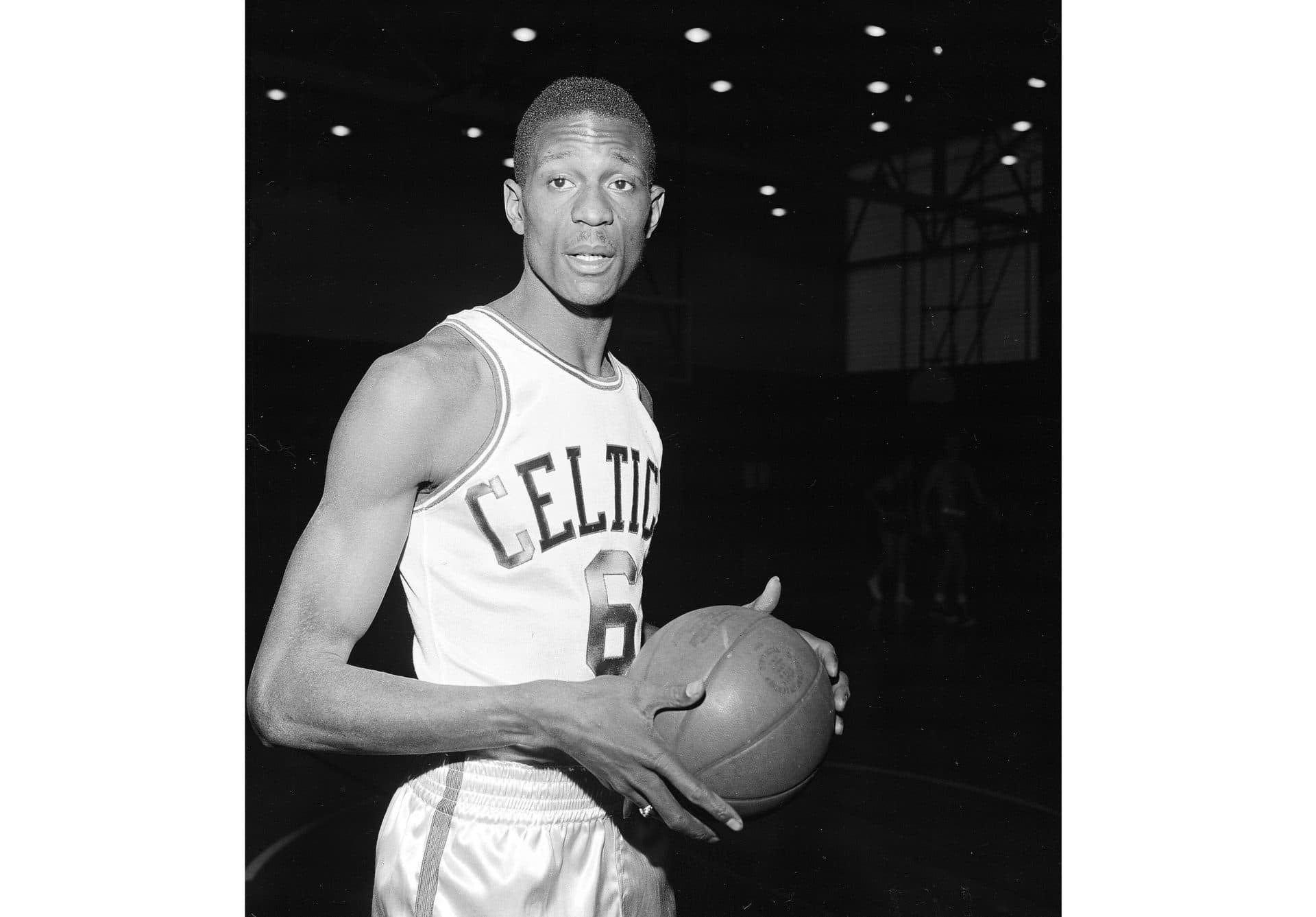 Bill Russell wears a Boston Celtics uniform for his first workout with the NBA team shortly after having signed a contract in Boston on Dec. 19, 1956. (AP)