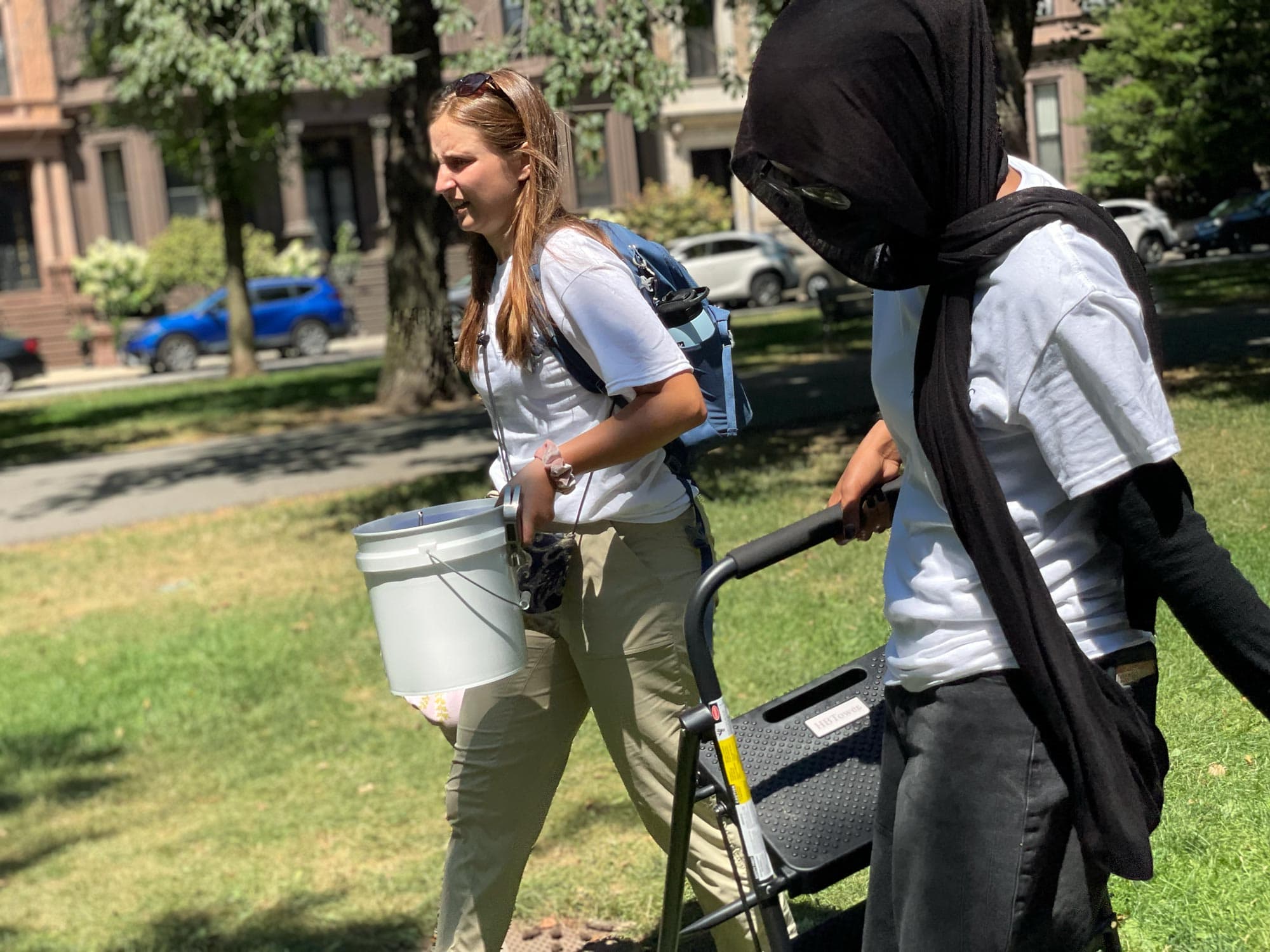 Sagal Yusuf (right) walks down the Commonwealth Avenue Mall with program supervisor Erin LeDrew. (Max Larkin/WBUR)