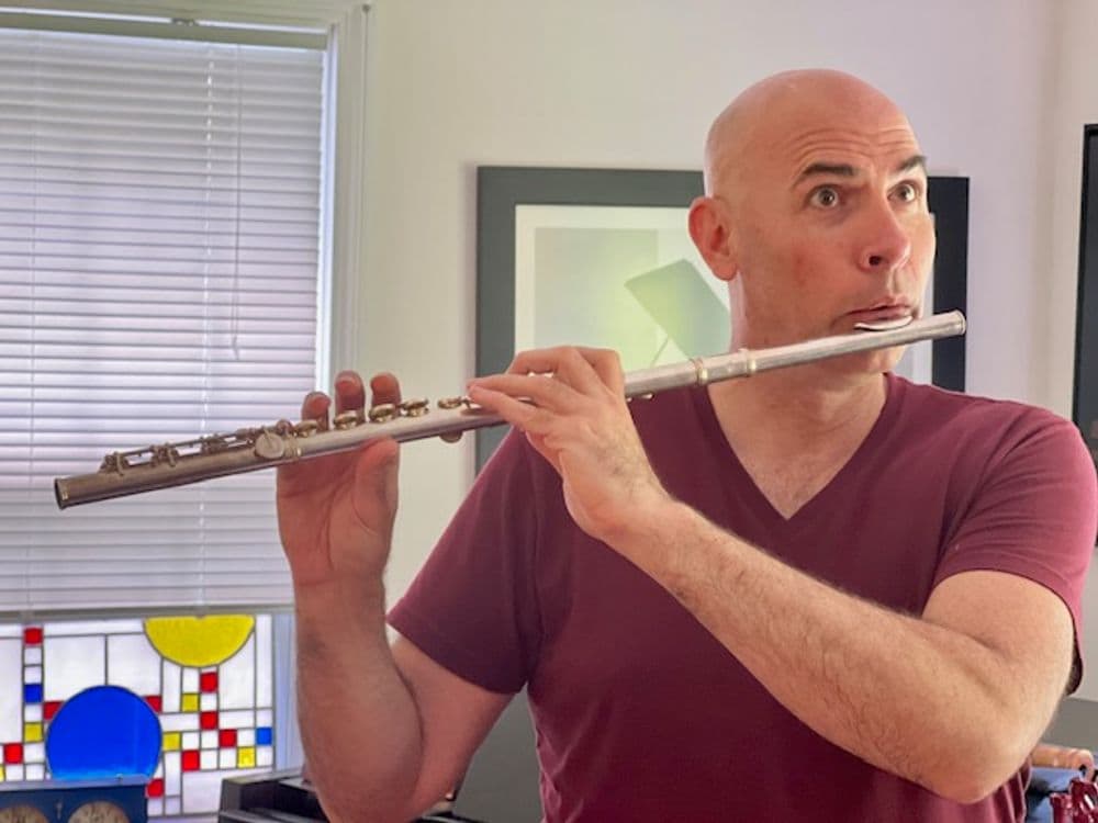 Eric Shimelonis playing the flute, a woodwind instrument divided into three sections, or “joints”: the head joint, middle joint and foot joint. (courtesy of Rebecca Sheir)