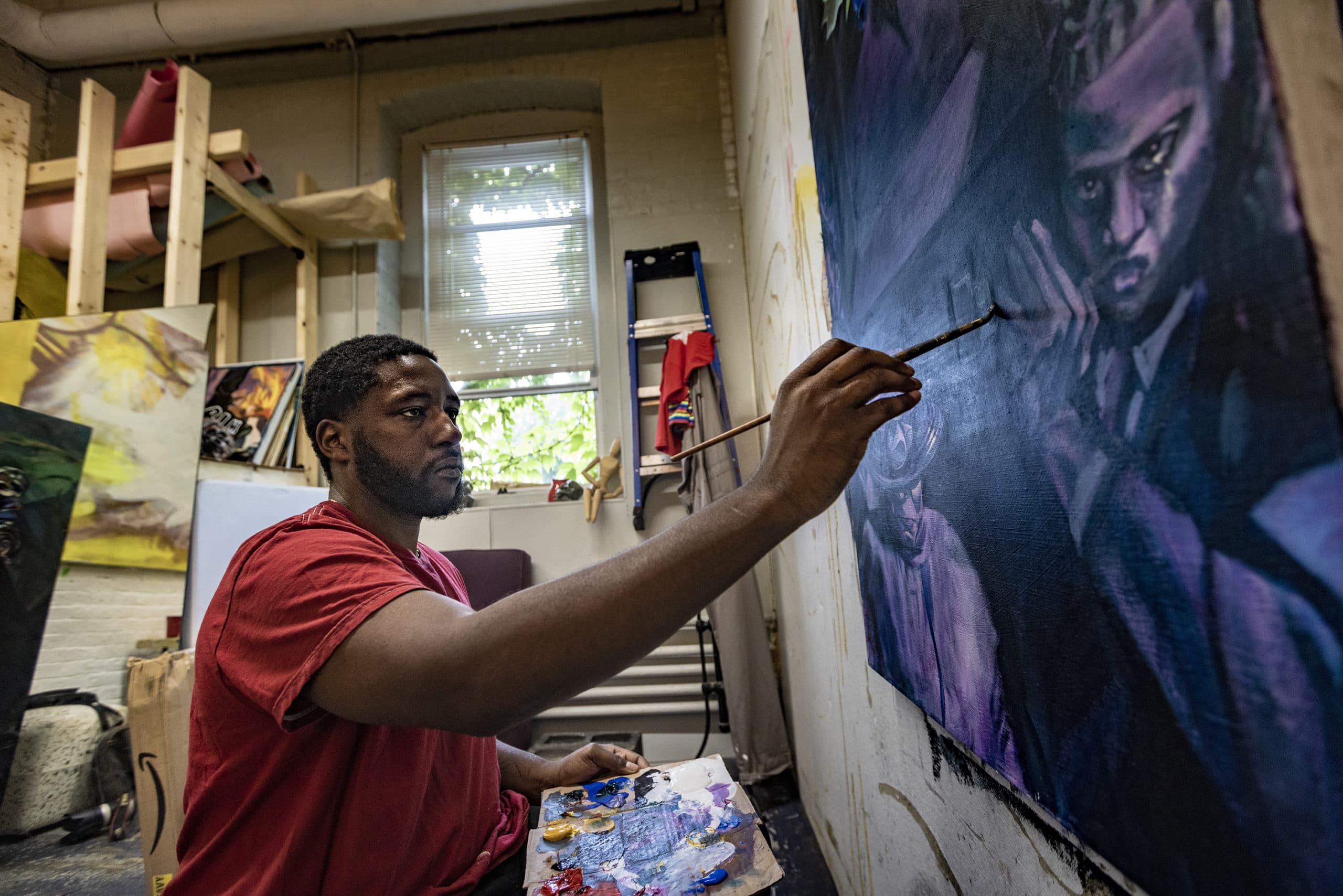 Michael Aghahowa working in his studio in Lynn. (Jesse Costa/WBUR)